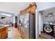 A chef's kitchen with hardwood flooring, stainless steel appliances, and a doorway to a laundry room at 418 Thaxton Ln, Woodstock, GA 30188