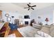Cozy living room featuring a fireplace, hardwood floors, comfortable seating, and natural light at 418 Thaxton Ln, Woodstock, GA 30188