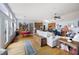 Open-concept living area with hardwood floors, lots of seating, and views of the kitchen and dining area at 418 Thaxton Ln, Woodstock, GA 30188