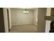 A clean and bright dining room featuring a carpeted floor and a stylish chandelier at 4525 N Landing Dr, Marietta, GA 30066