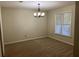 Dining room with neutral carpet, chandelier, and a window letting in plenty of natural light at 4525 N Landing Dr, Marietta, GA 30066