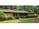 Charming single-story home featuring a stone accent wall, covered porch, and well-maintained landscaping at 4525 N Landing Dr, Marietta, GA 30066