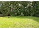 Expansive backyard with lush green grass, mature trees, and a wooden fence, perfect for outdoor activities and privacy at 936 Tyrell Dr, Austell, GA 30106