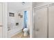 Bright bathroom featuring a tub, toilet, and a glass enclosed shower at 936 Tyrell Dr, Austell, GA 30106