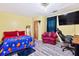 Comfortable bedroom with yellow walls, modern flooring, and a TV for entertainment at 936 Tyrell Dr, Austell, GA 30106