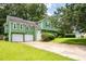Charming green home with a two-car garage and a well-manicured lawn at 936 Tyrell Dr, Austell, GA 30106