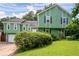 Inviting two-story home with green siding, lush lawn and mature landscaping at 936 Tyrell Dr, Austell, GA 30106