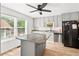 Contemporary kitchen with updated appliances, laminate flooring, and an island counter at 936 Tyrell Dr, Austell, GA 30106