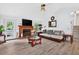 Spacious living room featuring a fireplace, neutral furniture, and ceiling fan at 936 Tyrell Dr, Austell, GA 30106