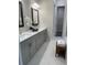 Stylish bathroom with double vanity sinks, light grey cabinets and view into the walk-in closet at 1026 Cagle Creek Ovlk, Canton, GA 30115