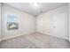 Bedroom features gray carpet, two windows with blinds, and white walls and trim at 1026 Cagle Creek Ovlk, Canton, GA 30115