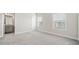 Bedroom with gray carpet, light gray walls, two windows with blinds, and view into bathroom at 1026 Cagle Creek Ovlk, Canton, GA 30115