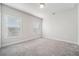 Carpeted bedroom features gray walls, white trim, and two windows with blinds at 1026 Cagle Creek Ovlk, Canton, GA 30115