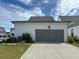 A detached two-car garage with gray doors and white siding at 1026 Cagle Creek Ovlk, Canton, GA 30115