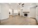 Spacious living room featuring a fireplace with stone accents and an open concept to the modern kitchen at 1026 Cagle Creek Ovlk, Canton, GA 30115