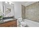 Bathroom featuring a tub, tiled wall, granite counter tops and a peek at the stairs at 120 Daniel Creek Ln, Sugar Hill, GA 30518