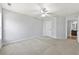 Spacious bedroom with neutral walls, a ceiling fan, and a sunlit window provides a relaxing retreat at 120 Daniel Creek Ln, Sugar Hill, GA 30518