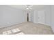 This bedroom has carpeted floors, a ceiling fan, and multiple access doors at 120 Daniel Creek Ln, Sugar Hill, GA 30518