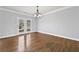Open dining room with hardwood floors and access to the patio at 120 Daniel Creek Ln, Sugar Hill, GA 30518