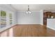 Open dining room with hardwood floors and access to the patio at 120 Daniel Creek Ln, Sugar Hill, GA 30518