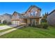 Two-story brick home featuring a well-kept lawn and a two-car garage at 120 Daniel Creek Ln, Sugar Hill, GA 30518