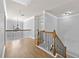 Hallway upstairs featuring wood floors and iron railing staircase at 120 Daniel Creek Ln, Sugar Hill, GA 30518