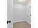 Functional laundry room has tile flooring, wire shelving, and utility connections for laundry appliances at 120 Daniel Creek Ln, Sugar Hill, GA 30518