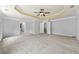 Spacious main bedroom features a tray ceiling and access to a luxurious en-suite bathroom at 120 Daniel Creek Ln, Sugar Hill, GA 30518