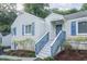 Quaint home with gray siding, blue shutters and door, complemented by manicured landscaping and mature trees at 1279 Skyhaven Se Rd, Atlanta, GA 30316