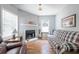 Cozy living room featuring a classic fireplace, hardwood flooring, and bright windows at 1279 Skyhaven Se Rd, Atlanta, GA 30316