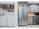 The kitchen area with stainless steel fridge and attached laundry room at 52 Chaumont Nw Sq, Atlanta, GA 30327