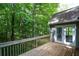 Expansive wooden deck overlooking lush greenery, creating a serene outdoor retreat for relaxation and enjoyment at 55 Legend Creek Cv, Douglasville, GA 30134