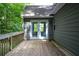 Wooden deck with double doors from the house, offering a private outdoor space for relaxing and entertaining at 55 Legend Creek Cv, Douglasville, GA 30134