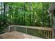 Wooden deck overlooking a lush, green forest, providing a serene and private outdoor space at 55 Legend Creek Cv, Douglasville, GA 30134