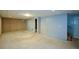 Spacious unfinished basement provides potential for customization, featuring concrete and painted walls, plus access to stairs at 55 Legend Creek Cv, Douglasville, GA 30134