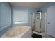 Corner tub and separate shower in a bright bathroom at 55 Legend Creek Cv, Douglasville, GA 30134