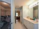 Bright bathroom featuring double sink vanity, a walk-in closet and neutral tile floors at 55 Legend Creek Cv, Douglasville, GA 30134