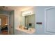 Double sink vanity in a well-lit bathroom with neutral tones and a view of the bedroom at 55 Legend Creek Cv, Douglasville, GA 30134