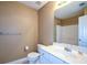 Neutral bathroom featuring white cabinets and a single sink with a large mirror at 55 Legend Creek Cv, Douglasville, GA 30134