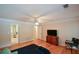 Spacious bedroom with hardwood floors, ceiling fan, and access to the bathroom, offering a functional space at 55 Legend Creek Cv, Douglasville, GA 30134