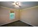 Bright bedroom featuring neutral walls, carpet flooring, and a window with a shade at 55 Legend Creek Cv, Douglasville, GA 30134