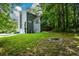 Exterior view of a charming home with a well-maintained lawn and mature trees, blending comfort and natural beauty at 55 Legend Creek Cv, Douglasville, GA 30134