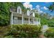 View of a charming two-story home with a inviting front porch at 55 Legend Creek Cv, Douglasville, GA 30134