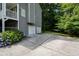Spacious two-car garage with a large driveway and beautiful landscaping, offering convenience and curb appeal at 55 Legend Creek Cv, Douglasville, GA 30134