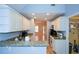 Kitchen boasts granite countertops, white cabinets and appliances, and an open view to the entryway at 55 Legend Creek Cv, Douglasville, GA 30134