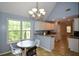 Charming kitchen featuring a breakfast nook, modern lighting, and granite countertops, perfect for casual dining at 55 Legend Creek Cv, Douglasville, GA 30134