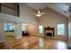 Open living room with wood floors, fireplace, vaulted ceiling and seamless access to the kitchen and dining areas at 55 Legend Creek Cv, Douglasville, GA 30134