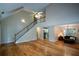 A spacious living room with wood floors flows to a staircase, dining room and kitchen at 55 Legend Creek Cv, Douglasville, GA 30134