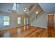 A large living room with wood floors and vaulted ceilings provides an airy living space at 55 Legend Creek Cv, Douglasville, GA 30134