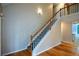 Open staircase with hardwood floors and white railings, leading to a bright upper level at 55 Legend Creek Cv, Douglasville, GA 30134